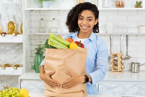 Woman with groceries in hand